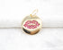 A round gold charm features an inset of sparkling pink cubic zirconia stones shaped like lips.