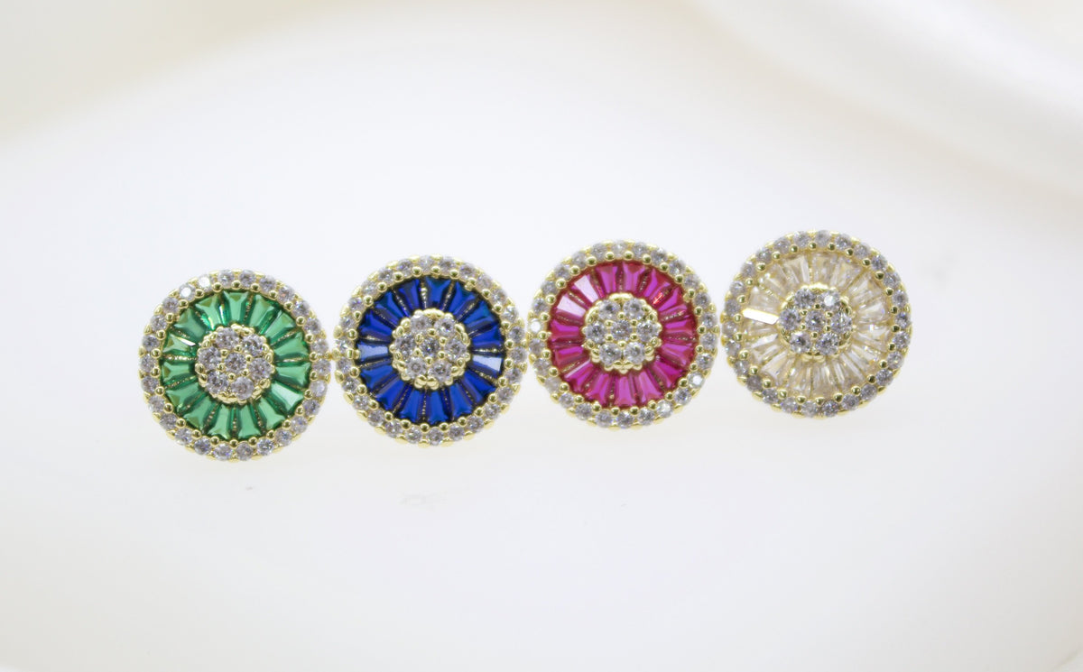 Four gold gemstone cluster earrings featuring round center stones surrounded by green, blue, pink, and white baguettes sparkle against a white background.