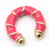 A chunky pink enameled hoop earring features gold bands wrapped around its body and polished gold ball terminals.