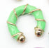 A bright green and gold enamel hoop earring rests against a white background.