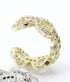 A gold pavé ear cuff sparkles brightly against a clean white background.