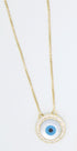 A delicate gold chain holds a round evil eye pendant sparkling with pavé stones.