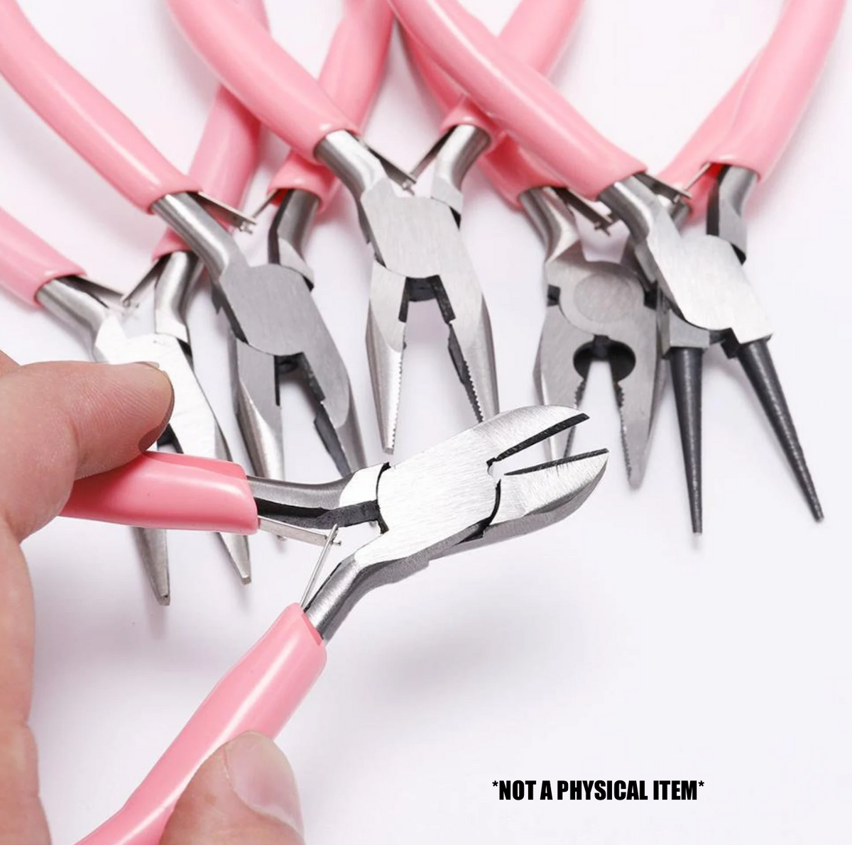 A hand holds a pair of pink-handled wire cutters, with a variety of jewelry pliers arranged in the background.