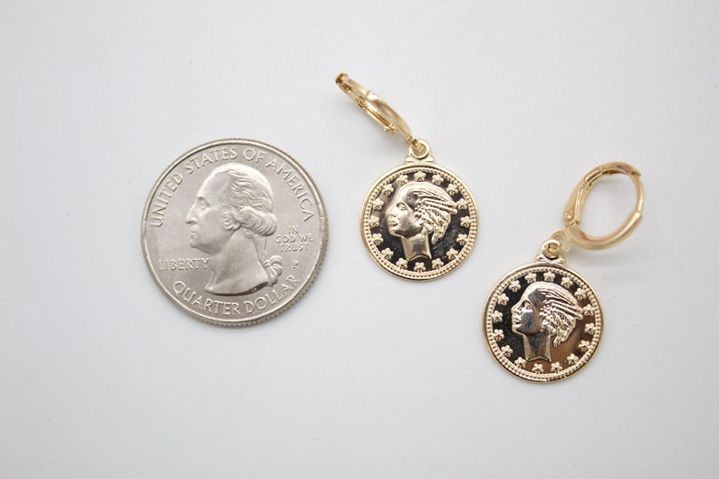 Two gold coin leverback earrings rest next to a US quarter on a white surface, demonstrating their size.