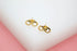 A pair of polished gold infinity symbol stud earrings rest on a white display surface.