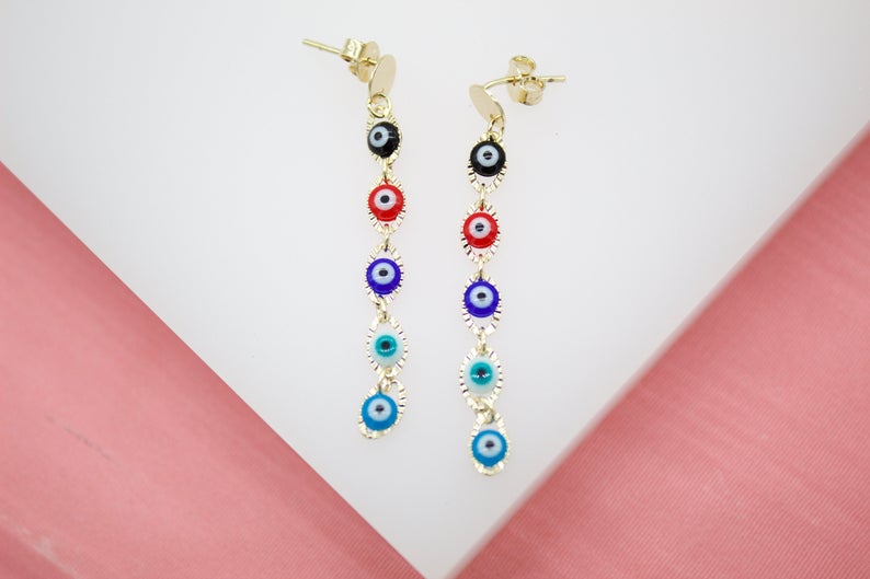 A pair of gold dangle earrings showcases a colorful stack of evil eye charms in black, red, royal blue, turquoise, and light blue.