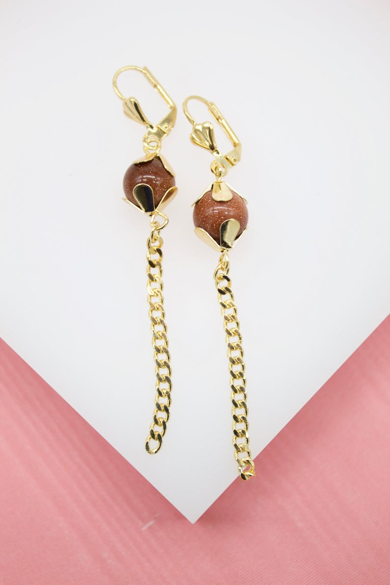 A pair of gold-plated dangle earrings feature sparkling brown sandstone beads held in floral settings with hanging curb chains.