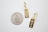 A pair of gold MAMA rectangle dangle earrings lies next to a US quarter coin for scale on a white surface.