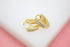 A pair of elegant gold huggie hoop earrings featuring sparkling pave-set cubic zirconia stones rests on a white display surface.