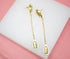 A pair of elegant gold chain drop earrings features white and gold cowrie shells on a white display block.