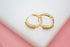 Two small gold hoop earrings feature rows of sparkling clear cubic zirconia stones.