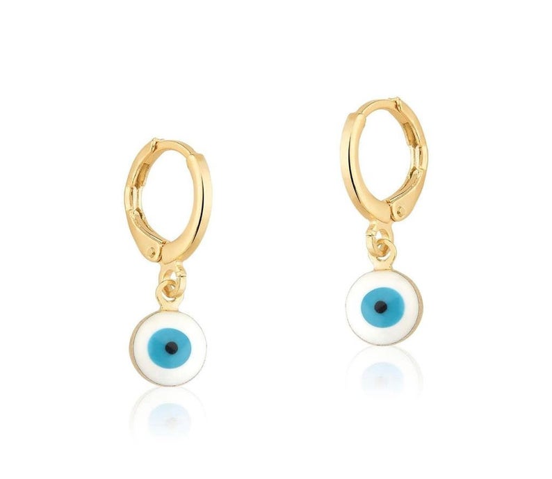 A pair of gold evil eye hoop earrings features dangling enamel charms designed with blue, white, and black concentric circles.