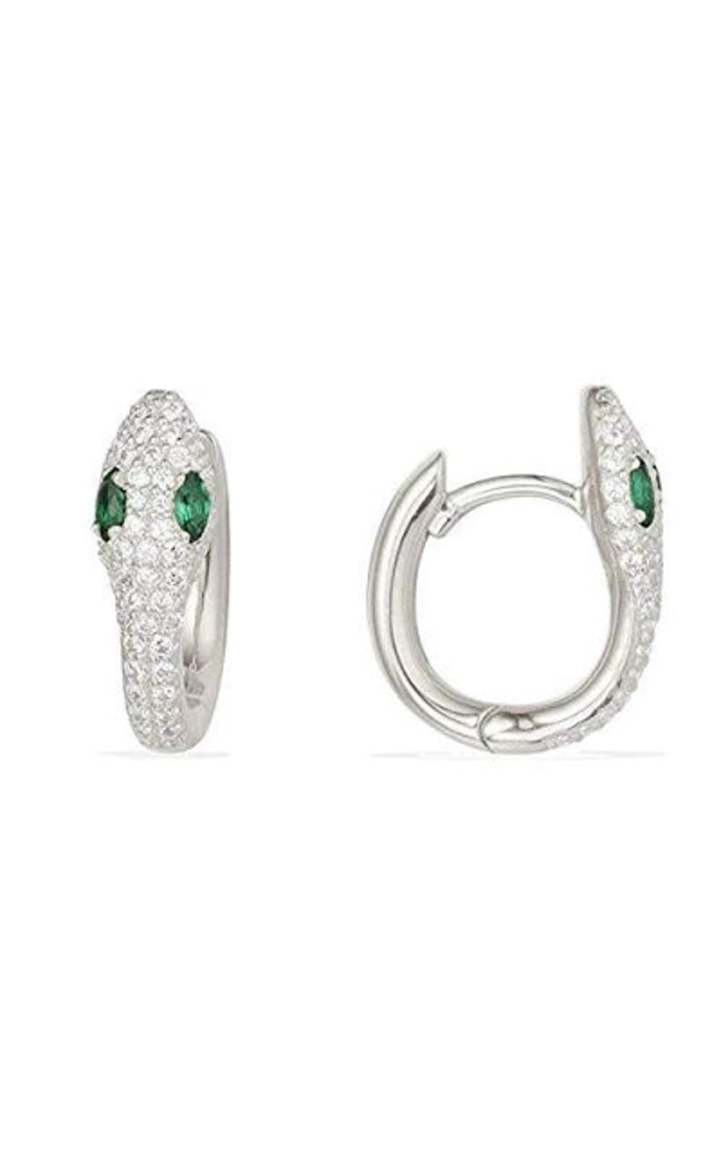 A pair of silver snake hoop earrings features pavé-set crystals and vibrant green marquise eyes against a clean white background.
