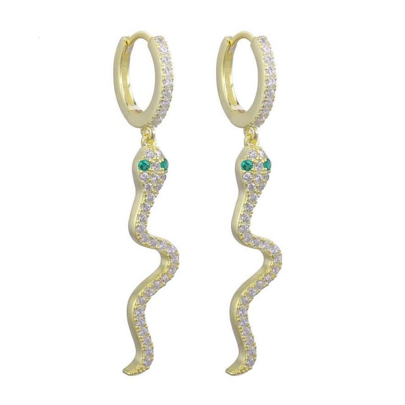 A pair of gold snake hoop earrings sparkle with pave cubic zirconia and vivid green gemstone eyes against a plain white background.