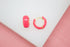 A pair of vibrant neon pink enamel hoop earrings rest on a white surface.