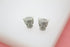 A pair of sparkling silver panther-shaped stud earrings sparkle with pave-set cubic zirconia stones and vivid green crystal eyes against a clean white surface.