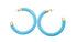 A pair of bright turquoise enamel hoop earrings featuring gold-capped ends display vibrant color against a plain white background.
