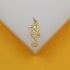 A gold seahorse pendant features sparkling cubic zirconia stones along its back against a light background.