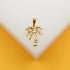 A gold palm tree pendant rests on a white display against a warm yellow background.