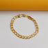 A shiny gold curb chain bracelet lies flat on a clean white surface with a yellow background.