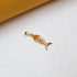 A polished gold fish bone pendant rests on a clean white surface.